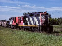 For most eastern folks, CN 4414 (or any of the heavy GP9's) is/was something all to familiar. In Redwater AB, it was an oddity. In just over a week it made 3 round trips through town. In this photo (trip No.3), the cab hop was made into a train by picking up 5 empty hoppers out of the Egremont siding. The cab has been tacked back on and it's off to somewhere north for 4 days. 