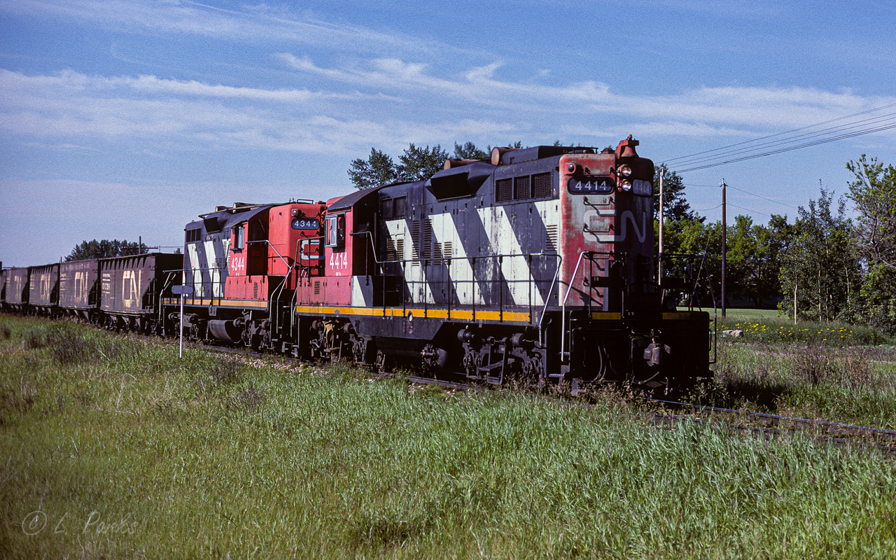 For most eastern folks, CN 4414 (or any of the heavy GP9's) is/was something all to familiar. In Redwater AB, it was an oddity. In just over a week it made 3 round trips through town. In this photo (trip No.3), the cab hop was made into a train by picking up 5 empty hoppers out of the Egremont siding. The cab has been tacked back on and it's off to somewhere north for 4 days.