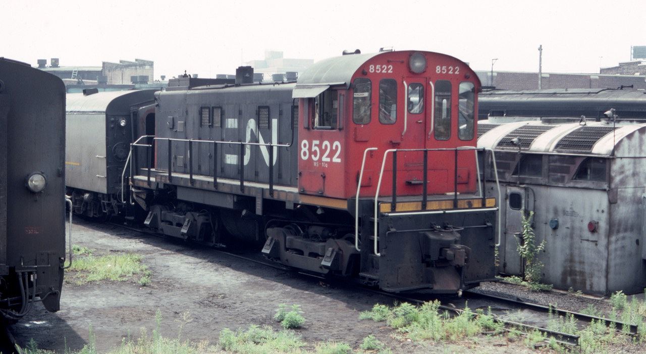 One of the many S-13 switchers that were constantly moving passenger equipment around the Union Station complex is shown parked at the diesel terminal in August of 1983. In addition to the CN 8522 shown here, there was quite a collection of whatnot on hand at the engine house.