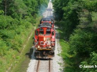 On a summer afternoon, CN L568 is viewed just west of New Hamburg, Ontario as it heads to Stratford on the CN Guelph Subdivision with GP9RM 4130 and GP38-2 4716 light power. 