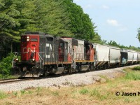 CN L568 is viewed heading west to Stratford with GP9RM 7068 and GP40-2L(W) 9555 passing Mile 68 on the Guelph Subdivision, just west of Kitchener. 