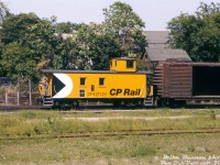 Very fresh looking CP Rail wooden caboose 437124 (a "van" in CP parlance) tags along on the rear of a CP local freight passing through the Weston area of Toronto on CP's MacTier Sub. The reweight/shop date on its side reads "ON 3-77" (Ogden Shops, March 1977), meaning it was only 3 months out of the paint booth, possibly also "modernized" at the same time with plywood side panels and roofwalks removed, both common modifications done to CP's old wooden van fleet. With a crewmember riding the rear porch, it's unclear if it's trailing the train or leading on a backup move, but leading he'd need an air whistle hooked up to the trainline to signal for the crossings. That old CP 40' double door boxcar with both doors open may be enroute for spotting at a local customer.<br><br>It's hard to place this shot, but it appears to be just south of King Street grade crossing, north of GO/CN's <a href=https://www.railpictures.ca/?attachment_id=51315><b>Weston Station</b></a>. CP's <a href=https://www.trainweb.us/oldtimetrains/CPR_Toronto/stns/weston.htm><b>Weston Station</b></a> was once just to the south at John Street, the town of Weston had wanted to save it but CP demolished it in 1974, apparently despite a stop-work order issued (<a href=http://www.railpictures.ca/?attachment_id=14408><b>sound familiar?</b></a>). The <a href=http://www.railpictures.ca/?attachment_id=18561><b>tracks through this corridor</b></a> of Weston at the time included the two CP MacTier Sub mainlines, a CN-CP interchange track just in front of the caboose, a CN customs/bond/team/service track in the foreground, and CN's Weston Sub mainline along with a passing siding (both would be in the foreground at the bottom of this photo, out of frame). In the 1960's, the switch off CN to the interchange was at CN "Moffat" (named after the nearby stove company), at Mile 8.8 Weston Sub (just north of Weston, Mile 8.6), but by the 70's that name and reference had been eliminated from timetables.<br><br><i>Mike Bannon photo, Dan Dell'Unto collection slide.</i>