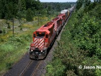 During a hot summer afternoon, a westbound CP train is viewed approaching the east siding switch at Puslinch, Ontario on the Galt Subdivision with SD40-2’s 5629, 5578 and SD40 5536. 