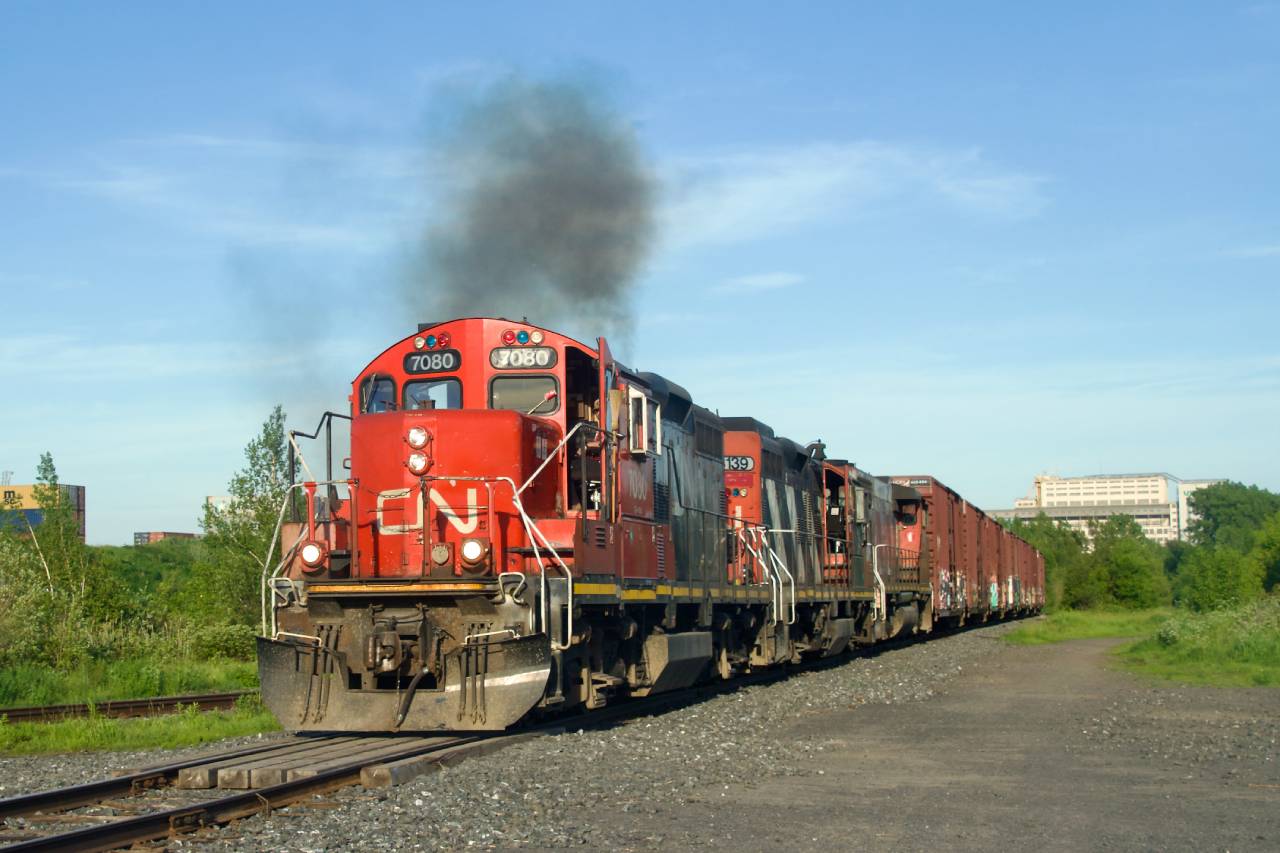 CN YRP003 heads towards a client in east end Montreal after being stopped here a bit, with none of the units loading properly (CN 7080, CN 4139 & CN 4774).