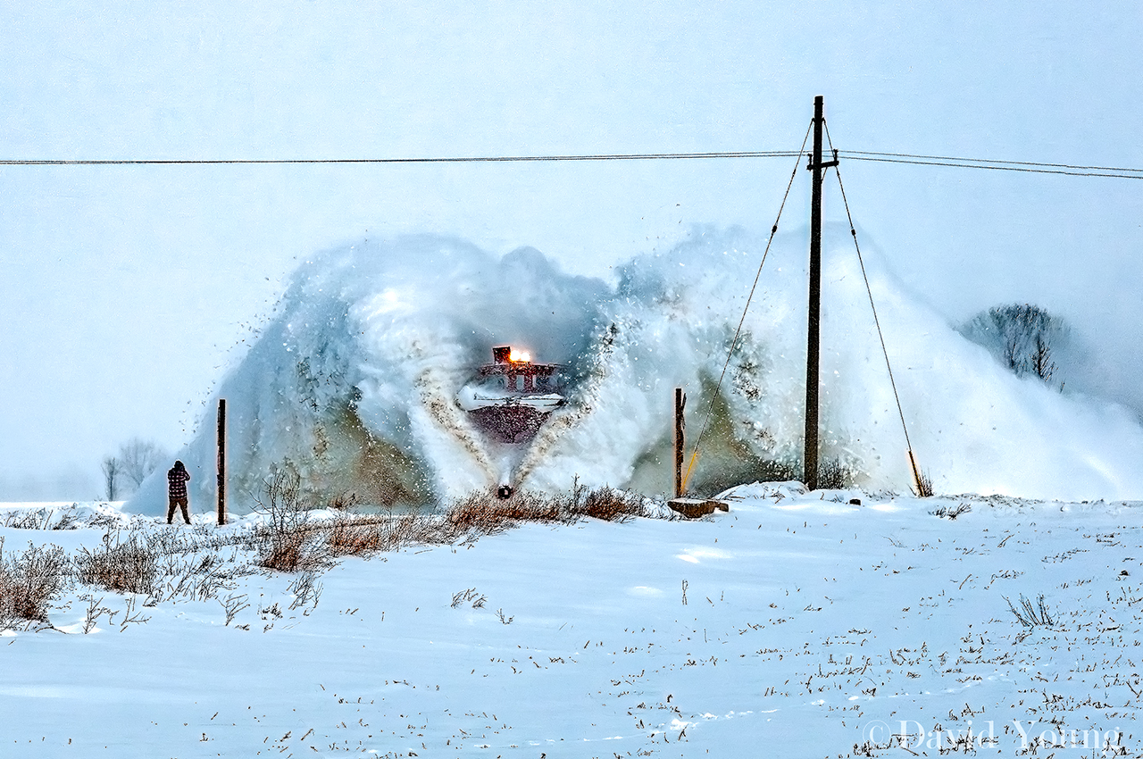 I title this one The Man and the Monster. A railfan stands his ground at Mapleton Line as the steel beast flinging snow from the right of way closes in at track speed. Truly one of the most dramatic scenes I've ever captured. Plows are fun to capture and some of the best frames are captured from a distance, magnifying the brilliance and sheer power of a pair of 1950 era diesels propelling a century old wedge plow through a snow drift.