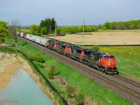 CN M396 is seen ducking beneath the new Mississauga Road overpass approaching the Norval crossovers.  The bridge recently opened during this past winter, <a href=https://www.railpictures.ca/?attachment_id=59492>replacing the grade crossing.</a>