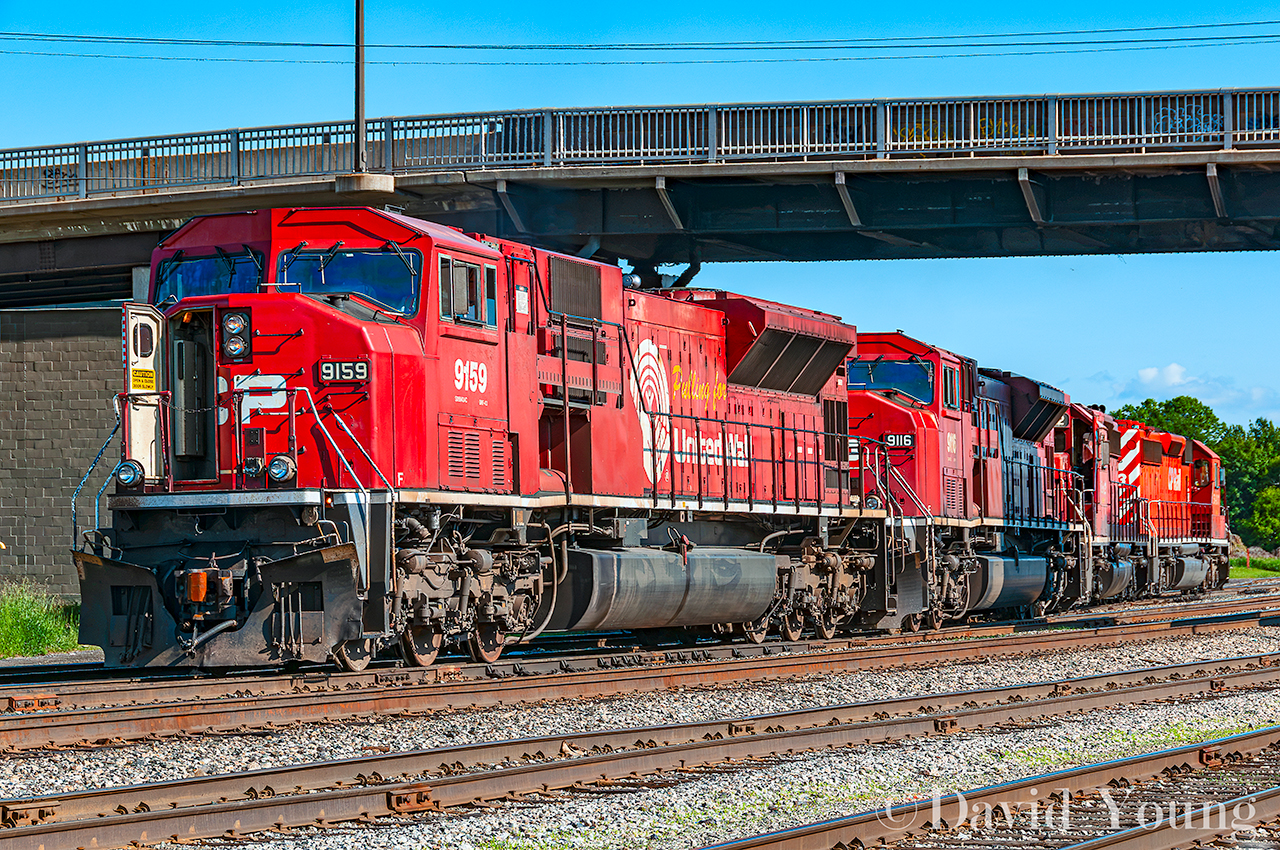 Having yarded their train in New Yard, the Schreiber crew of Toronto to Thunder Bay freight 221 snakes across the East End crossover for the shops with an all EMD lash up led by "Pulling for the United Way" CP 9159. Sister SD9043MAC 9116 trails with a pair of SD40-2's.