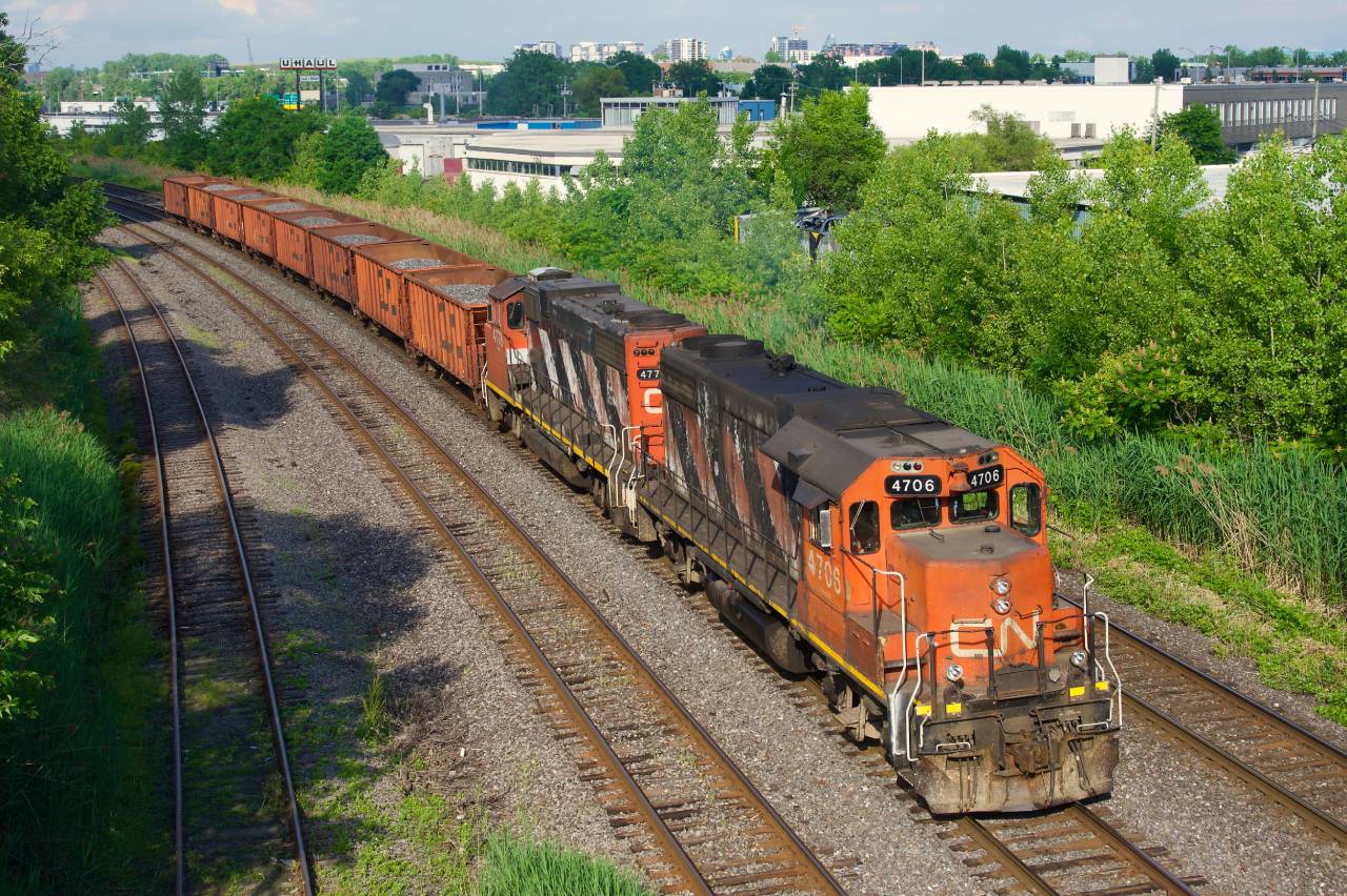 CN 596 is westbound towards Taschereau Yard with what were described as 'rush' ballast loads, possibly for a derailment on the La Tuque Sub.