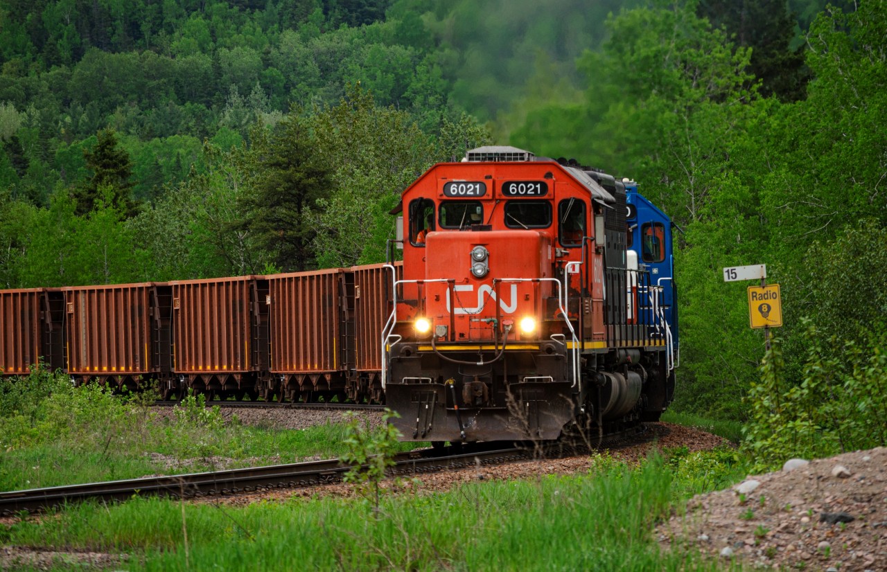 A loaded train of bauxite climbs the hill out of Port-Alfred at UGBEst junction with one of 2 leased CN SD40us leading the train.
