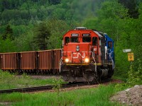 A loaded train of bauxite climbs the hill out of Port-Alfred at UGBEst junction with one of 2 leased CN SD40us leading the train.