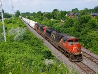 A shorter than usual CN 322 is about to pass MP 14 of CN's Kingston Sub on a sweltering morning.