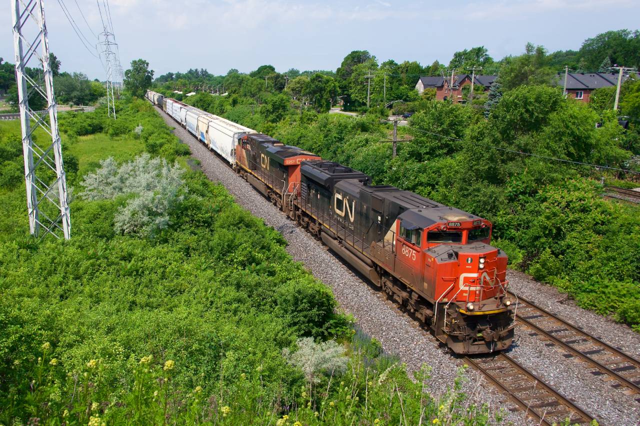 A shorter than usual CN 322 is about to pass MP 14 of CN's Kingston Sub on a sweltering morning.