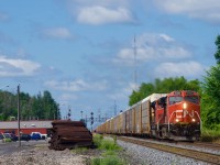 Hot on the heels of CN 368, CN 276 passes Coteau Station with CN 3358 leading. Barely visible behind the station is parked local power.