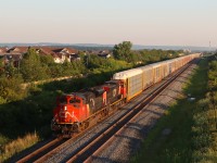 E275 operating on what is now the North Track at Mile 37.7 Halton Sub., about to pass under Louis St. Laurent Ave. with 94 cars trailing through the start of double track at Derry and onto the single track between Derry and Milbase.

