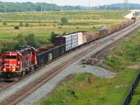 L551 with the GTW 6425 CN 4936 heading eastbound toward Milton with a good size train today. L551 is operating on the newly constructed south track between Mile 38.9 and Derry Mile 36.9, having just passed over the future parallel right hand crossovers which will form part of a new Controlled Location. The former main track, now the north track is partially new construction before being cut into the existing track. The former main track can be seen off to the right, portions of which will eventually form one of two yard leads for what will become the east entrance/exit to the Milton Logistic Hub. The former Controlled Location Ash, Mile 38.8 has been removed.

