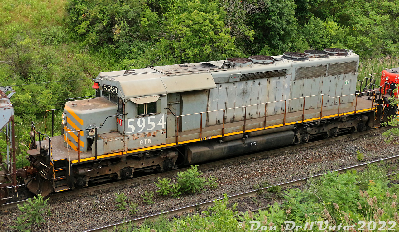 On an eventful trip around Maple on Canada Day in 2022, we stopped by the pullback tracks at CN's MacMillan Yard on the way home before dinner. The usual hump sets have an SD40Q, slug, and another SD40-variant trailing. This set with 6003 and 250 had a nice surprise today: GTW SD40-3 5954! Built as a standard SD40 by GMD in May of 1971 as CN 5185, it was retired and rebuilt by Alstom in 1998 to lease to KCS, before being leased and later purchased back by CN. Unlike the CN 6000-series SD40Q units that had their cabs, noses and other details modified, the rebuilt Alstom SD40-3 units still retain most of their "SD40 look".