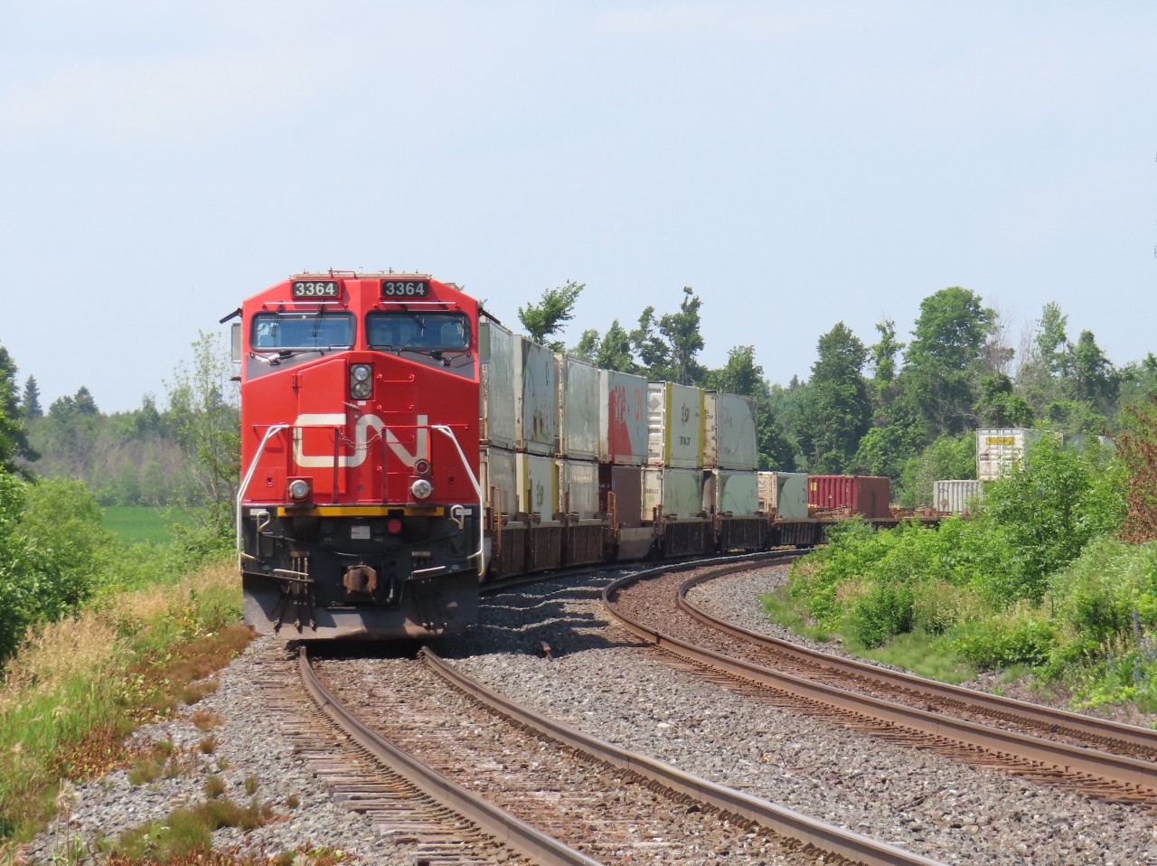 On a sweltering 33 degree day, a southbound intermodal waits in the siding at Brechin. Good thing modern locomotives have air conditioning.