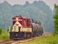 The forest fire smoke from northwestern Ontario is very visable thanks to shifting winds, as OSR’s job to Tilsonburg heads south just out of Salford, with three tank cars in tow. They will have over an hours work in Tilsonburg before heading back north. 