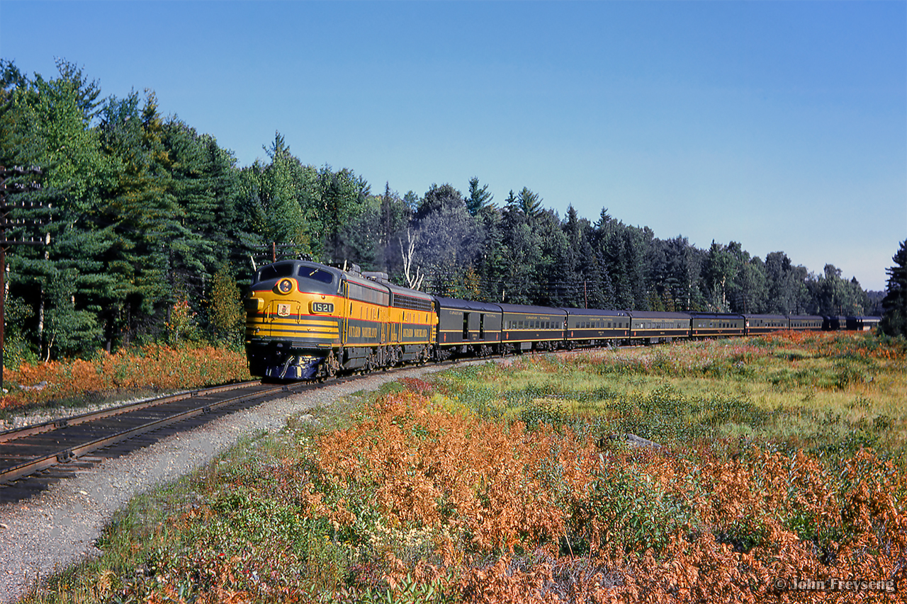 The weekend of September 13 - 15, 1963 marked a massive undertaking by the Upper Canada Railway Society, a 692.2 mile excursion from Toronto - Ottawa - North Bay - Temagami - Toronto, with seventeen coaches behind CNR 6167. With the train having run overnight from Toronto - Ottawa on the 13th, the train turned west and departed the nation's capital early on the 14th. 6167 would be removed at North Bay, with ONR FP7s handling the train to Temagami overnight. The consist returned to North Bay on the morning of the 15th, with 6167 taking over once again for the return to Toronto.

About halfway back to North Bay from Temagami, passengers have detrained for a runpast, as the pair of green and yellow FP7s round the curve at approximately mile 31.5, roughly the area of the settlement of Jocko.  [Geotagged located not exact]

Running across northern Ontario
Arrival at North Bay.

Further information will be detailed in upcoming posts, but can also be found in the December 1963 UCRS news letter.

Scan and editing by Jacob Patterson.