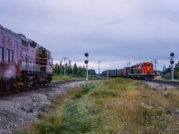 Algoma Central Hearst - Sault St. Marie train 2 pauses at Oba to wait for a westbound CN freight to clear the diamond on the Ruel Sub.  Leading the westbound is the only two GP35 units purchased by CN, 4001 and 4000, recently released from GMD London.<br><br><a href=https://www.railpictures.ca/?attachment_id=54251>Pausing at the station</a><br><a href=https://www.railpictures.ca/?attachment_id=59048>The head end</a><br><br><i>Scan and editing by Jacob Patterson.</i>