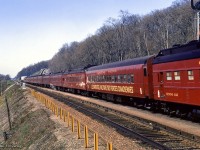 Touring the nation as part of the 1967 centennial celebrations, one of the two trains carrying the Canadian Armed Forces Military Tattoo climbs the grade at Dundas, bound for an evening performance in Sarnia. The tattoo was designed to operate as three parts, with part 1 being the initial tours of the two trains from late March through mid May, performing arena shows with 450 performers. One consist was made up of CN equipment, known as 'train A,' and carried the 'blue' group of performers, while the other was made up of CP equipment, aka 'train B,' carrying the 'red' group of performers. In late May, both groups combined, and additional performers added, bringing the total to about 1700 for the next stage of shows; stadium performances from late May through August. The final part of the tattoo would be smaller shows beginning in late summer, and wrapping up in mid October. Further reading can be found on Keith Allan Wilson's Tattoo 1967 website, as well as the itinerary of events for the year.  More photos to come, and more details on this can be found in Tom Henry's article in the April 1967 UCRS newsletter.

<br><br><a href=https://www.railpictures.ca/?attachment_id=59393>Approaching the scene</a>

<br><br><i>Scan and editing by Jacob Patterson.</i>