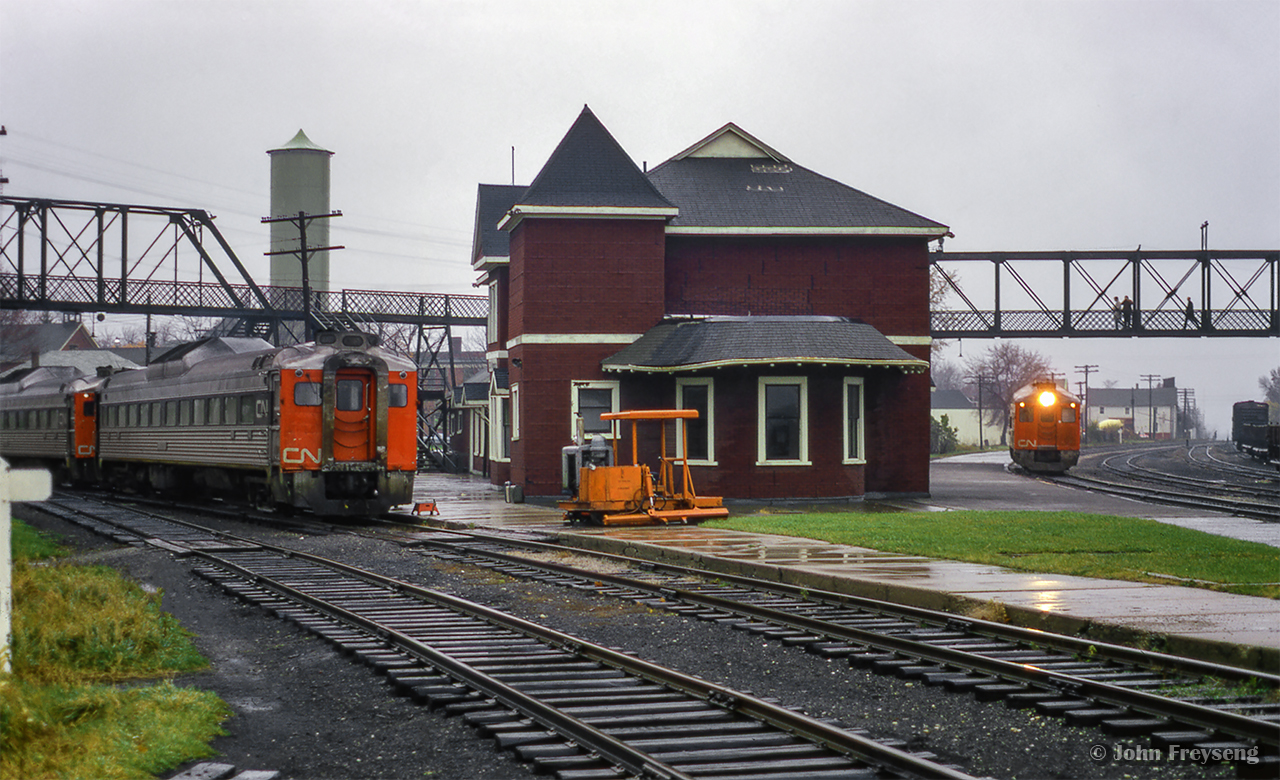 Operating as extra 6354, former train number 668 - the southbound RDC-2 passenger car from Owen Sound- is seen arriving at Palmerston, where RDC-1 6101 sits nosed up to CN 6118 on the Newton Sub side of the station on Saturday, October 24, 1970. Both 6101 and 6354 will be combined, and will depart at 0715h for the trip to Toronto (formerly train 658) via the Fergus, Guelph, Halton, and Weston Subs. Extra 6118 will too depart at 0715h for Stratford.

The official last runs of the RDC service to Owen Sound, Kincardine, Southampton, and Goderich was the evening of Friday, Oct 23, 1970. Though these services continued to operate to Toronto (and Stratford) as extras until the end of the month. Daylight saving time ended early Sunday morning, Oct 25, 1979, and CN and CP would bring out their winter timetables at this time change.

Scan and editing by Jacob Patterson.

More shots from this date:
Extra 6101 arriving at Palmerston
Extra 6101 spotted on the Newton Sub
Extra 6354 arriving at Palmerston
All three RDCs lined up at the station
Waiting on the Newton Sub