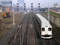 Cab car GO 9851 trails on an eastbound train for Pickering crossing over from track 3 to 4 at Dufferin approaching Exhibition GO, while a westbound pair of self-propelled cars can be seen on track 1 making their station stop.
<br><br><i>Scan and editing by Jacob Patterson.</i>
