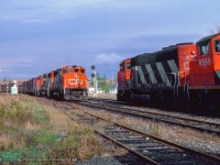 Northbound CN 9531 holds the main at Pefferlaw for a meet with extra 9422 south, taking the siding with a train of what appears to be wooden box or MoW cars.

<br><br><i>John Freyseng Photo, Jacob Patterson Collection Slide.</i>
