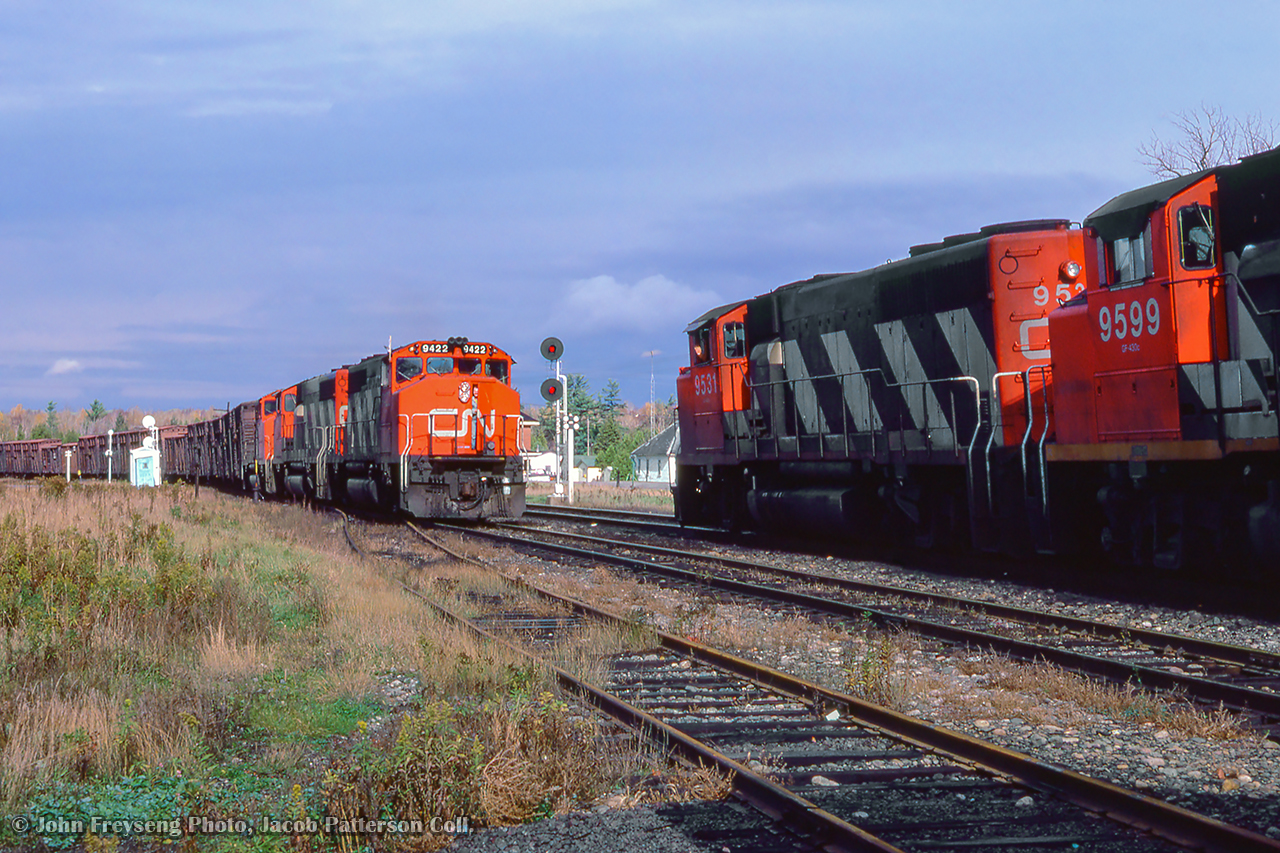 Northbound CN 9531 holds the main at Pefferlaw for a meet with extra 9422 south, taking the siding with a train of what appears to be wooden box or MoW cars.

John Freyseng Photo, Jacob Patterson Collection Slide.