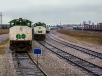 Looking back from the cab of <a href=https://www.railpictures.ca/?attachment_id=56684>the Guelph Junction road switcher,</a> three GO Transit consists are viewed tied down at Guelph Junction awaiting their next runs to Toronto.  A GP40TC and two APCUs bring up the <a href=https://www.railpictures.ca/?attachment_id=58788>east end of the consists.</a>

<br><br><a href=https://www.railpictures.ca/?attachment_id=56795>Departing for Waterdown North.</a>

<br><br><i>John Freyseng Photo, Jacob Patterson Collection Slide.</i>"   height=