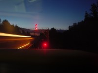 8/11/01 The summer sun has not even set at 8:21pm as my train is in the siding at Beare on CN's York Sub. The RTC put a lot of faith in me to get my train in the clear before the eastbound hotshot was on the approach to Beare. The RTC was very happy.
In front of my train is a dwarf signal displaying red and somehow I was able to catch the headlight of the eastbound train as it moves under the bridge carrying CP's Belleville Sub. 