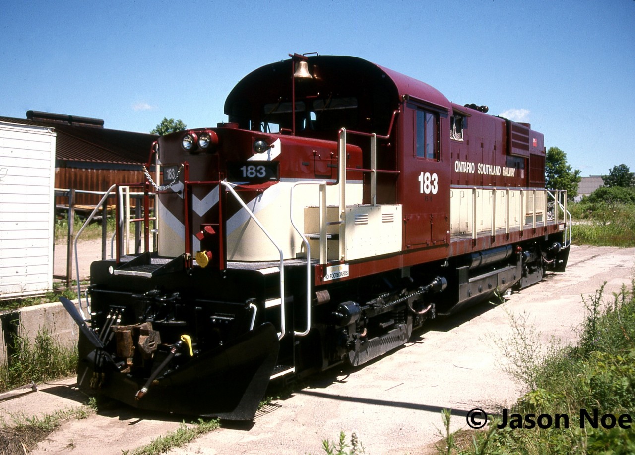 In July 1996, Ontario Southland Railway RS18 183 is viewed in fresh paint in St. Thomas. Eventually, the unit would be assigned to Tillsonburg and work on the Tillsonburg Spur (former CP Port Burwell Subdivision) to Ingersoll. Built with a low nose in 1968, RS18 183 is ex-Inco 208-3 and was acquired by OSR the previous year. It had been stored at Inco’s facility in Thompson, Manitoba before heading to Ontario. It was briefly numbered OSR #3 before entering the former Michigan Central shop in St. Thomas during July 1995 for work. At the time, I believe this was the first OSR unit to be adorned in the corporate colours of the railway.