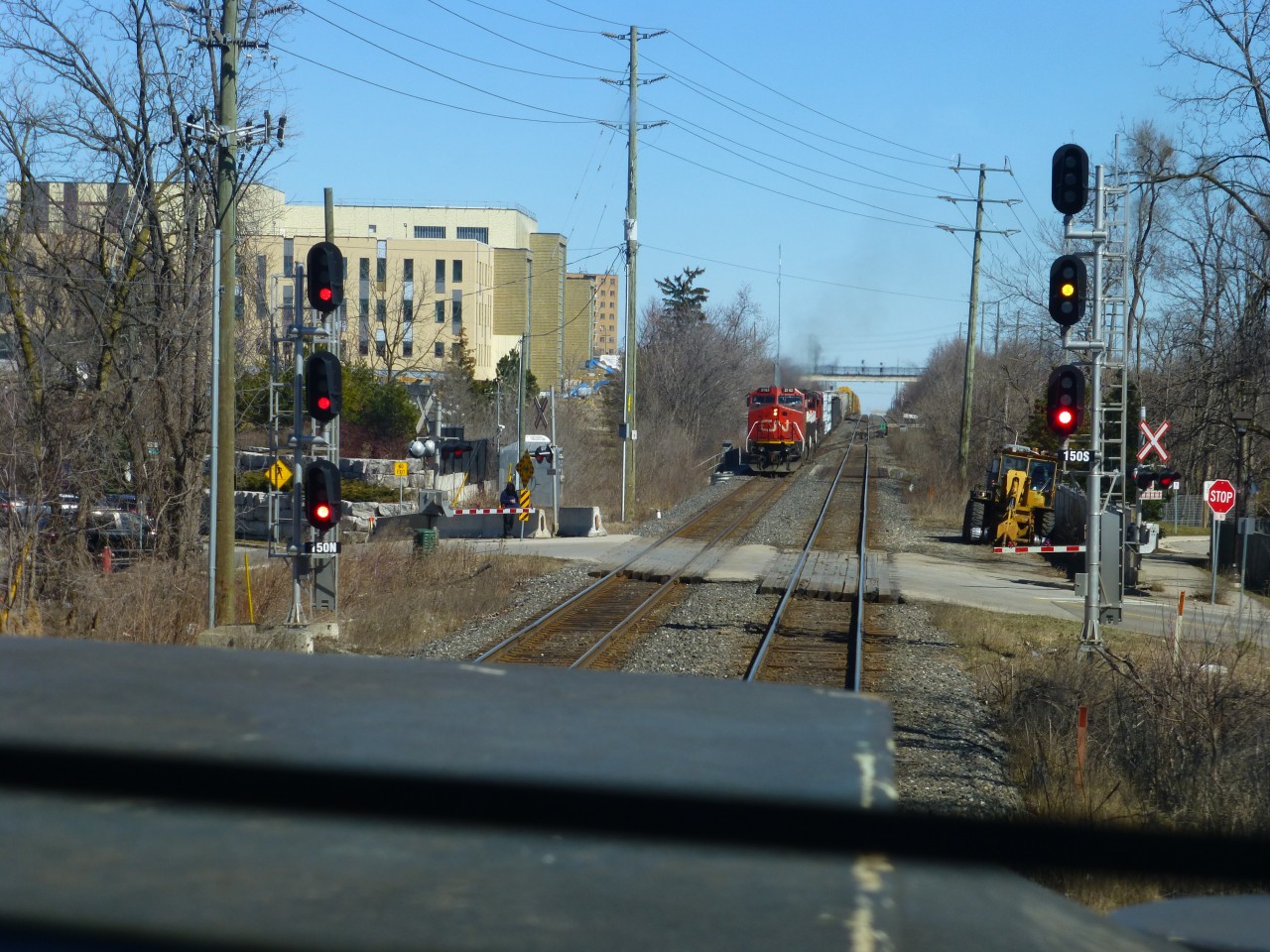 3/19/16. My  Mac Yrd bound train has just crossed over the diamond at Brampton,Ont on CN's Halton Sub as we meet a  westbound freight lead by ex AT&SF "gull wing" C40-8W(ATSF 841 BNSF 841 ). Now numbered CN # 2182. I was so happy when the company put in a 
One Way Low Speed / OWLS" diamond, so the CN trains no longer had to do 30mph(50mph now)  crossing the old diamond. The diamond at Carew on the Dundas Sub also has an OWLS crossing.(60mph)