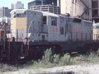 Quebec North Shore and Labrador GP9 #169 is seen near Toronto Union Station in July of 1982. There is an interesting mix of old railroad structures and city skyline in the background. All changed today.