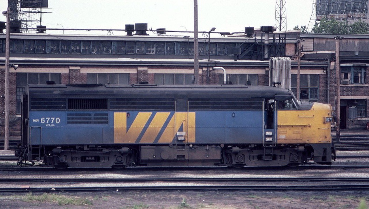 A side view of Via Rail MLW FPA-4 6770 in July of 1982. Note the railroad buildings and industrial scene behind the unit. Not the glitzy and glassy Toronto of today. What a time to be photographing trains back then.