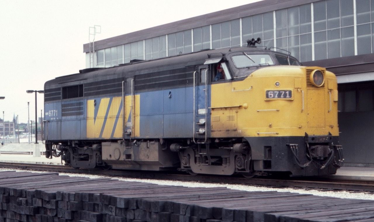 Via MLW FPA4 6771 is shown alongside Toronto Union Station in July of 1982. It looks like the maintenance of way forces have a lot of work ahead of them based on that stack of railroad ties!