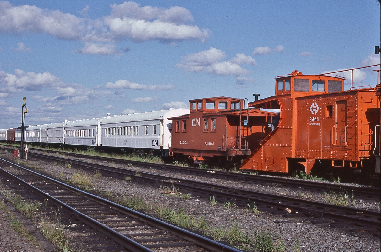 What ever happened to the Newfie Bullet rolling stock...


...some re-assigned to non-revenue service as Terra Transport work service, Auxiliary & maintenance.


Centrally located on The Rock, at Bishop's Falls, August 3, 1982 Kodachrome by S.Danko


Plow #3468, Flanger #3678 and next two are bunk cars (#50xx) and the box car red coach in the distance is CN #5013 ' Bunk Kitchen & Dining Car'


Main, trans – Island, track in the foreground.


sdfourty