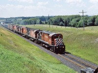 <br>
<br>
 A rather oily Century...
<br>
<br>
...heads up CP Rail Eastbound with 4207 – 4247 – 4203 – 8778 – 4705 (DH), 
<br>
<br>
As far as I can determine only the RS-18  8778 found a second tour as a rebuild to: 1858
<br>
<br>
At the Bee Bridge(s), Nichols Road July 26, 1987 Kodachrome by S.Danko
<br>
<br>
With a pair of ConRail brown 'mini hi cubes' on the head end, 
<br>
<br>
Look closely bottom right: a burnt Bee Bridge, a spring grass fire burned the south end of the CP Rail bridge & closed the bridge.
<br>
<br>
By 1998 CP Rail 1858 (and a bunch of sisters) to New Brunswick East Coast Railway, 1858 retired June 2002.
<br>
<br>
sdfourty