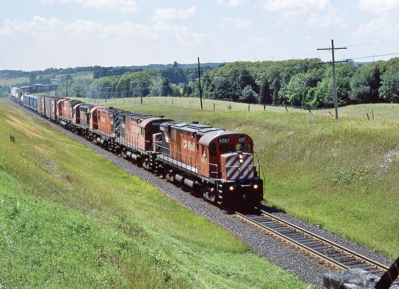 A rather oily Century...


...heads up CP Rail Eastbound with 4207 – 4247 – 4203 – 8778 – 4705 (DH), 


As far as I can determine only the RS-18  8778 found a second tour as a rebuild to: 1858


At the Bee Bridge(s), Nichols Road July 26, 1987 Kodachrome by S.Danko


With a pair of ConRail brown 'mini hi cubes' on the head end, 


Look closely bottom right: a burnt Bee Bridge, a spring grass fire burned the south end of the CP Rail bridge & closed the bridge.


By 1998 CP Rail 1858 (and a bunch of sisters) to New Brunswick East Coast Railway, 1858 retired June 2002.


sdfourty