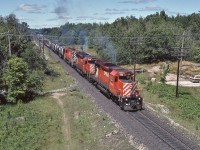 <br>
<br>
Fun times on the Mac (tier),
<br>
<br>
a pair of SD's helped by a Century leaving the yard limits,
 <br>
<br>
South end Mactier,  CP Rail #52,  August 11, 1985 Kodachrome by S.Danko
<br>
<br>
Power: 5911 – 5926 – 4232
<br>
<br>
Parked at the Lake Joseph Road turnaround  is the Parisienne 'Atlantica'  (of The Rock fame):
 1979 Pontiac Parisienne Safari with a 350 cu. in. V-8, with a 4 bbl Rochester Quadrajet carburetor.
<br>
<br>
sdfourty
