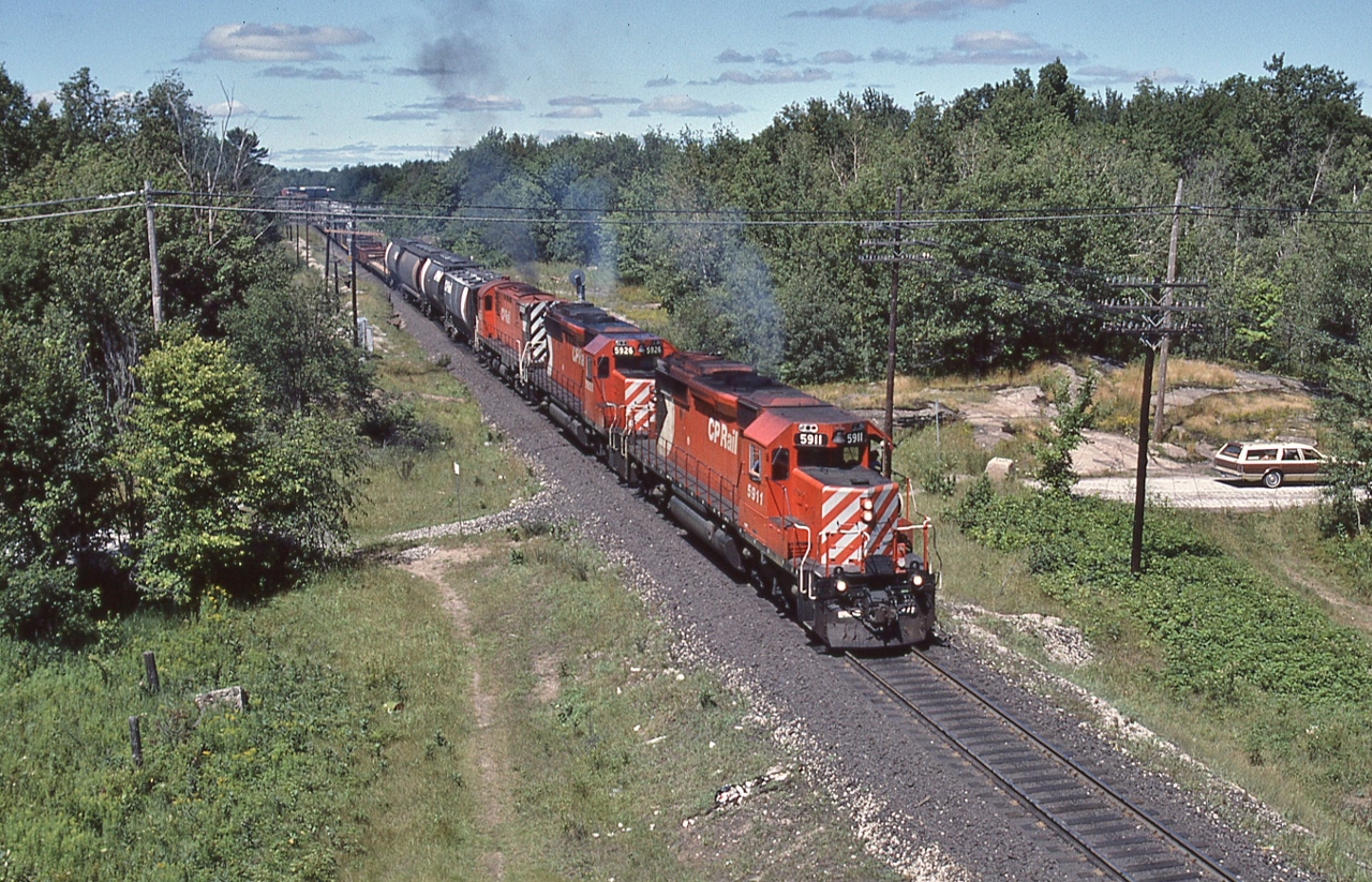 Fun times on the Mac (tier),


a pair of SD's helped by a Century leaving the yard limits,
 

South end Mactier,  CP Rail #52,  August 11, 1985 Kodachrome by S.Danko


Power: 5911 – 5926 – 4232


Parked at the Lake Joseph Road turnaround  is the Parisienne 'Atlantica'  (of The Rock fame):
 1979 Pontiac Parisienne Safari with a 350 cu. in. V-8, with a 4 bbl Rochester Quadrajet carburetor.


sdfourty