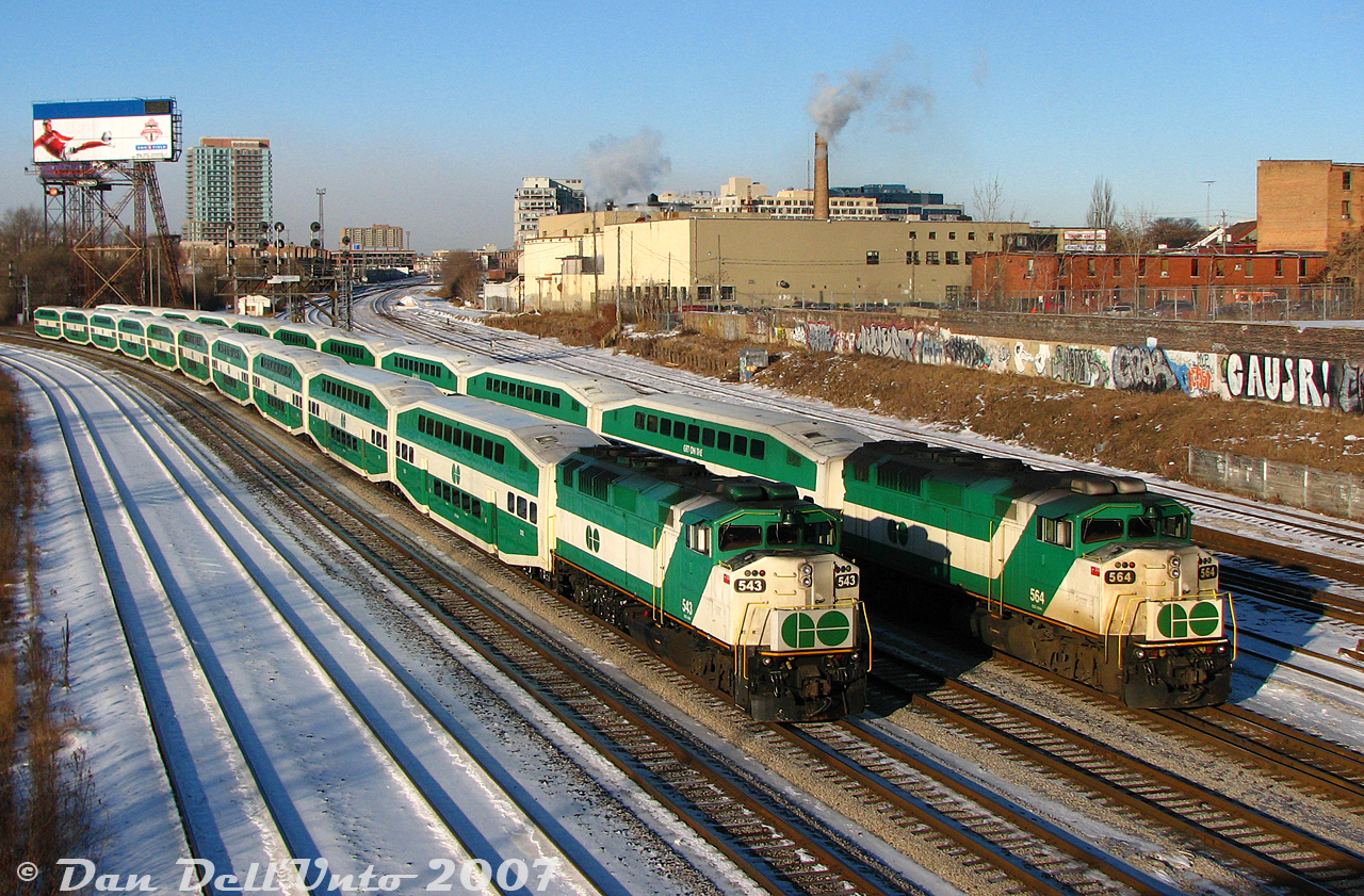 It was cold on Bathurst Street bridge that morning, very cold, but tolerable for photos of recently rebuilt VIA F40PH-2D 6400 making its first trip west on The Canadian at 9am. As the minutes tick down to the top of the hour, other morning trains pass through, some inbound full of commuters and some outbound running empty. Two identical GO Transit "L10" consists, with F59PH units 543 and 564 both pushing, sit at Bathurst Street awaiting the light to head westbound back to Willowbrook Yard after completing their morning runs. The Quality Meat Packers abattoir was still "going at full ham" in the background, and would be for another few years until it closed down in 2014.F59PH 543 would be another one of those F59's to leave and rejoin the roster (sold to AMT/exo as 1340, purchased back by GO as GOTX 582), while 564 would be one of the eight F59's retained and rebuilt for continued service.