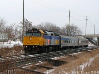 After shooting <a href=https://www.railpictures.ca/?attachment_id=59750><b>VIA #84 at Fletcher's Creek</b></a>, a quick jaunt was made Bovaird Drive for the OBRY (a no-show, <a href=http://www.railpictures.ca/?attachment_id=53272><b>it came later</b></a>) then across to Mount Pleasant GO station for VIA #85 due in about half an hour. Today's consist, lead by F40PH-2D 6431 and #85's usual two Budd HEP cars, blasts through Mount Pleasant like a scalded jackrabbit after ducking under the Bovaird Drive/Highway 7 overpass, hell-bent on exiting the Brampton city limits and hitting its next stop at Georgetown before jumping onto the Guelph Sub at Silver. #85 was usually up to a pretty good clip through here, as passenger track speed was about cheetah speed at 70 mph, and 3000 horsepower was more than enough to get two Budds up the grade from downtown Brampton (I've got video of #85 flying through Mississauga Road crossing to the west, for the day Steve makes a railvideos.ca...). Then an <a href=http://www.railpictures.ca/?attachment_id=10434><b>FPON-crazy #394</b></a> showed up later downtown, which was nice.<br><br>In the mid-2000's, Mount Pleasant GO station was a bleak marker at the edge of civilization at the time: suburban growth encroaching to the east, but all rural farmland to the north, west and south that was waiting in the wings to be gobbled up and redeveloped. A farm had once existed just north of the station itself until it was cleared two years ago. There was no bustling walkable suburban neighbourhoods, no community centre, scant transit services with buses that didn't seem to want to be there, and a lonely GO station with barely any GO trains surrounded by a large empty parking lot (that sometimes had amorous individuals doing things on Sundays, shhh).<br><br>Mount Pleasant never had a train station until the current GO station was built in 2005. In the GTR/CN days, the nearest was Norval to the west, or the busier Brampton station a little further to the <a href=https://www.railpictures.ca/?attachment_id=59723><b>southeast</b></a>. Some reminders of its past as a small farming hamlet once known as "Pleasant" centered around Highway 7 and Creditview Road remained, such as the old Presbyterian church, an old restaurant/gas bar building and Beckford's Motel (pictured on the left), all located on the old dead-end alignment of Highway 7 (renamed Salvation Road) before it was bypassed with the current Highway 7 overpass sometime in the 60's. The only patrons I noted at the motel most days were a few trucks, and after it closed the Urban Explorer crowd did poke around a bit before it was ultimately demolished a few years later. The old former gas station/restaurant building looked boarded up and vacant at the time. An old 1950's photo of a CNR Northern passing by in 1958 shows there was likely an Esso gas bar out front back in the day, servicing through-traffic between Brampton, Norval and Georgetown that likely dwindled after the bypass. Both that building and the motel were demolished in the early 2010's for more GO commuter parking.<br><br>Today Mount Pleasant is a happier walkable transit city-type suburban place, where the railfans can graze on the platforms and shoot all sorts of modern CN GE and GO trains without the bleak reminder of suburban progress encroaching on farmland (maybe I just visited on too many cloudy winter days). It's also a popular hub of ZUM and Brampton Transit activity for the bus foamer types.