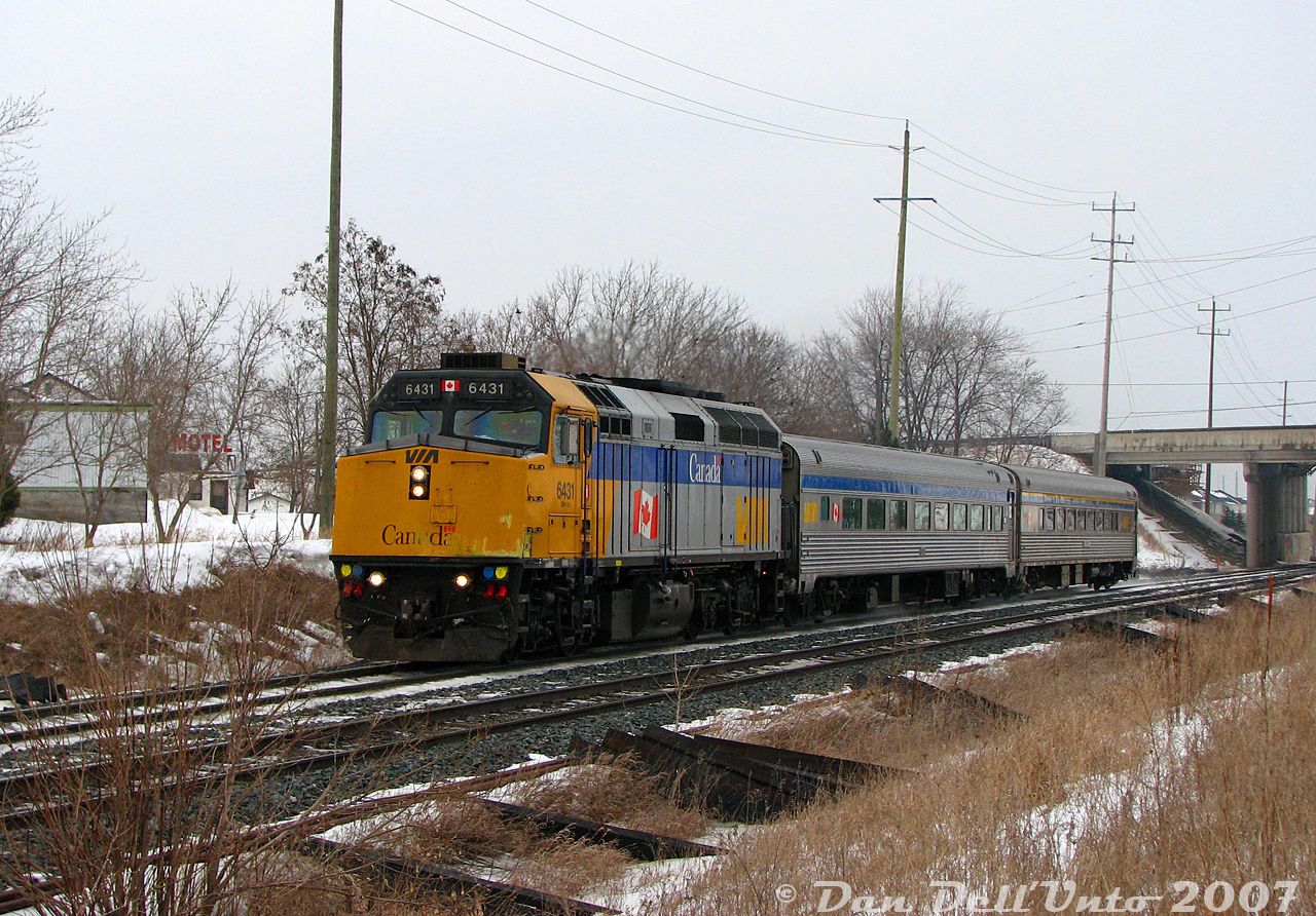 After shooting VIA #84 at Fletcher's Creek, a quick jaunt was made to Mount Pleasant GO station for VIA #85 due in about an hour. Today's consist, lead by F40PH-2D 6431 and #85's usual two Budd HEP cars, blasts through Mount Pleasant like a scalded rabbit after ducking under the Bovaird Drive/Highway 7 overpass, hell-bent on exiting the Brampton city limits and hitting its next stop at Georgetown before jumping onto the Guelph Sub at Silver. #85 was usually up to a pretty good clip through here, as passenger track speed was 70 mph and 3000 horsepower was more than enough to get two Budds up the grade from downtown Brampton (I've got video of #85 flying through Mississauga Road crossing to the west, for the day Steve makes a railvideos.ca...).

In the mid-2000's, Mount Pleasant GO station was a bleak marker at the edge of civilization at the time: suburban growth encroaching to the east, but all rural farmland to the west and south that was waiting in the wings to be gobbled up and redeveloped. There was no bustling walkable suburban neighbourhoods, no community centre, scant transit services with buses that didn't seem to want to be there, and a lonely GO station with barely any GO trains and a large empty parking lot (that sometimes had amorous individuals doing things on Sundays, shhh). Some reminders of its past as a small farming hamlet known as "Pleasant" remained, such as the old church and Beckford's Motel (pictured on the left), both located on the old dead-end alignment of Highway 7 (renamed Salvation Road) before it was bypassed with the current Highway 7 overpass. The only patrons I noted at the motel most days were a few trucks, and after it closed the Urban Explorer crowd did poke around a bit before it was ultimately demolished a few years later. An old 1950's photo of a CNR Northern passing by in 1958 shows there was likely an Esso gas bar out front of the motel back in the day.

Today Mount Pleasant is a happier walkable transit city-type suburban place, where the railfans can graze on the platforms and shoot all sorts of modern CN GE and GO trains without the bleak reminder of suburban progress encroaching on farmland (maybe I just visited on too many cloudy winter days). It's also a popular humb of ZUM and Brampton Transit activity for the bus foamer types.