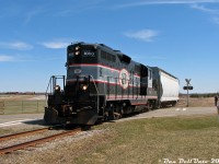 If you opened a dictionary and looked up "Shortline Railroading", this photo would sum it up nicely: the Orangeville-Brampton Railway's twice weekly run to <a href=http://www.railpictures.ca/?attachment_id=5178><b>Streetsville</b></a> to interchange traffic with CP (and to work the few industries enroute) has just left the suburban chaos of <a href=http://www.railpictures.ca/?attachment_id=3831><b>Brampton</b></a> and it making its way north through the <a href=http://www.railpictures.ca/?attachment_id=3770><b>Caledon countryside</b></a>. Traffic today consists of just a single covered hopper, and with interchange work done it's a straight shot all the way back to Orangeville. Track speed was 25mph with numerous slow orders/restrictions along the way.<br><br>Cando Contracting (CCGX) 1000, an old 1957 GMD GP9 (ex-QNS&L 157) that was the lone assigned power for the OBRY, is running long-hood-forward and laying on a little bit extra horn for the three photographers giving chase as it cruises past the Brampton-Caledon Airport and over McLaughlin Road, near the hamlet of Victoria. There's actually four RP.ca photographers here: <a href=https://www.railpictures.ca/author/david-young><b>Dave Young</b></a> and <a href=https://www.railpictures.ca/author/cncndr><b>Mike Da Costa</b></a> shooting at the crossing, me behind the camera, and <a href=https://www.railpictures.ca/author/runeight><b>Steve Bradley</b></a> in the cab as conductor on this run. <a href=https://www.railpictures.ca/?attachment_id=58339><b>Engineer Wayne</b></a> was giving 1000's half-clogged Leslie Supertyphon S3J horn a good workout at each crossing on the trip north, and both were nice enough to invite us to ride around in the cab in Orangeville before the unit was put away for the day. A fun time was had by all, with a good amount of photos and memories to look back through.