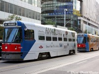 TTC CLRV's 4049 and 4070 bunch together like only Toronto streetcars can on two 505 Dundas runs, heading eastbound on Dundas Street approaching Yonge Street in the busy and bustling Yonge-Dundas Square area. The first car appears to be short-turning at Parliament Street (named after the original location of Parliament in the olde Upper Canada daze), while the unfortunate souls riding behind will be short-turned at Church to redeem themselves. The two streetcars are excellent specimens of the many wraps featured on the CLRV fleet over the years: 4049 wrapped for Bell Fibe TV, and 4070 wrapped for Global Toronto's The Morning Show with Liza Fromer (tune in Weekdays 6-9!).<br><br>They're passing Ryerson University's (they hate it when you call it that) Ted Rogers School of Management, the crown jewel of Rye's High's Faculty of Business built in 2005-06 on the site of a former Eaton Centre parking garage at Bay and Dundas, and replacing the old and mediocre Victoria building that was previously used by the business school (I've heard the stories from classmates...just a generally outdated building equivalent to attending a high school, nothing like poaching rats in the basement for extra credit or anything).<br><br>Open for business* in the fall of 2006, bragging rights at the time were that Ryerson finally had a proper "Business School on Bay Street" to compete with the likes of UofT's Rotman School of Management and York U's Schulich (I did attend there once - to use the washrooms, it was nice). For the first two years or so the new facility operated as the Ryerson Business Building (RBB), until a wheelbarrel full of cash rolling down Bay Street tipped over in front of it, and then it became the Ted Rogers School of Management (TRSM) in 2008 or so. It shared the building with commercial retail on the ground level including Canadian Tire, Best Buy, and Mark's Work Warehouse (a good source of soldering irons and golf shirts for those Bay Street finance interviews down the street), and has since remained the TRSM after the TEMU U rebrand. Most of their reviews on the Goog' are positive, so they must be doing something right.<br><br>*<i>Pun intended</i>.