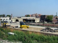 A view of the old Andrew Merrilees Ltd. railway supply company yard off Old Weston Road, one of the many sights from the GO train while passing through "The Junction" area in West Toronto. There were always lots of rail sections on site, and the ever-present Speedswing (parked in one of the garage bays). Some of the property had been temporarily cleared and cut back due to utility work the area, possibly preceding the future grade separation construction.<br><br>According to an old UCRS newsletter detailing his obituary (UCRS #363, January 1980), Andrew Merrilees was a railway historian and collector, originally from Hamilton, who formed Andrew Merrilees Ltd in 1946 for sale, salvage, purchasing, leasing and reselling of railway equipment and supplies. The company's <a href=https://www.trainweb.us/oldtimetrains/industrial/ont/merrilees.htm><b>West Toronto location</b></a> at 189 Old Weston Road operated for decades, no doubt doing a lot of local business with CN and CP practically (literally) <a href=http://www.railpictures.ca/?attachment_id=29758><b>on their doorstep</b></a>. They even had their <a href=http://www.railpictures.ca/?attachment_id=56951><b>own rail siding</b></a> for storing equipment at one point. Operations would wind down and the property sold in the Summer of 2016. There was even an old sagging wooden 40' outside-braced boxcar (likely ex-NYC) that survived <a href=https://www.google.ca/maps/@43.6689676,-79.4617375,3a,15y,113.36h,89.58t/data=!3m8!1e1!3m6!1s8hTBVmWIBWn1izT4tWgcLw!2e0!5s20150401T000000!6shttps:%2F%2Fstreetviewpixels-pa.googleapis.com%2Fv1%2Fthumbnail%3Fcb_client%3Dmaps_sv.tactile%26w%3D900%26h%3D600%26pitch%3D0.416113214851066%26panoid%3D8hTBVmWIBWn1izT4tWgcLw%26yaw%3D113.36111420139288!7i13312!8i6656?entry=ttu&g_ep=EgoyMDI2MDgwNS4xIKXMDSoASAFQAw%3D%3D><b>at the back of the property</b></a> for many years, likely finally scrapped when they were cleaning house before/after the sale.