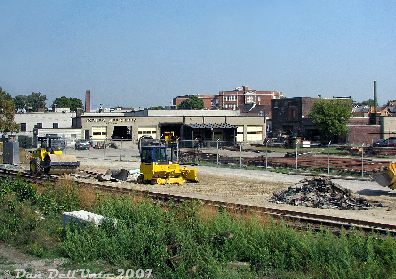 A view of the old Andrew Merrilees Ltd. railway supply company yard off Old Weston Road in "The Junction" at West Toronto. There were always lots of rail sections on site, and the ever-present Speedswing (parked in one of the garage bays). Some of the property had been temporarily cleared and cut back due to utility work the area, possibly preceding the future grade separation construction.

According to an old UCRS newsletter detailing his obituary (UCRS #363, January 1980), Andrew Merrilees was a railway historian and collector, originally from Hamilton, who formed Andrew Merrilees Ltd in 1946 for sale, salvage, purchasing, leasing and reselling of railway equipment and supplies. The company's West Toronto location at 189 Old Weston Road operated for decades, no doubt doing a lot of local business with CN and CP practically (literally) on their doorstep. They even had their own rail siding for storing equipment at one point. Operations would wind down and the property sold in the Summer of 2016. There was even an old sagging wooden 40' outside-braced boxcar (likely ex-NYC) that survived at the back of the property for many years, likely finally scrapped when they were cleaning house before/after the sale.