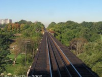 "It's 9:20am coming into the City of Toronto on a bright and sunny morning, and the traffic on Highway 401 in the distance is we don't care, because we're taking the GO train".
<br><br>
One of the more scenic spots along the Weston Sub is the old Grand Trunk Railway bridge crossing the Humber River, seen here out the rear of GO cab car 237 <a href=https://www.railpictures.ca/?attachment_id=59625><b>trailing train #252</b></a> into Toronto. Located just north of the town of <a href=http://www.railpictures.ca/?attachment_id=59712><b>Weston</b></a> at "<a href=https://www.railpictures.ca/?attachment_id=59244><b>CN McGill</b></a>", there's no shortage of lush green foliage in the area surrounding the river valley, part of which is home to the Weston Golf and Country Club's sprawling golf course on the floodplains below (see 1971 aerial <a href=https://www.toronto.ca/ext/archives/s0012/fl1971/s0012_fl1971_it0138.jpg><b>here</b></a>). Note the tall codeline/telegraph poles remaining alongside the bridge, and the lack of any handrails for safety (the small bridge platforms, relics from back in the day that used to hold fire barrels, remained for anyone brave or unsmart enough to cross on foot).
<br><br>
In the distance through the cut of trees, the line climbs up to <a href=http://www.railpictures.ca/?attachment_id=19261><b>Highway 401 overpass</b></a>, Islington Avenue and Etobicoke North GO station at the top of the hill. The two signs in the distance warn trains of the private golf course crossing. This stretch had been known to cause problems in the fall due to leaves on the tracks stalling <a href=http://www.railpictures.ca/?attachment_id=42775><b>freight trains</b></a> climbing the grade, like <a href=http://www.railpictures.ca/?attachment_id=34973><b>CN #577</b></a>, sometimes resulting in lengthy delays and cancellations to GO service (like that one time with two GP40-2LW's that had to double their train in the pouring rain, SNAFU'ing evening rush hour service on the Georgetown line).
<br><br>
This section had remained single track <a href=https://www.railpictures.ca/?attachment_id=25751><b>for decades</b></a> under GTR/CN until Metrolinx purchased the line in 2009, and proceeded to add three more tracks for expanded GO and new UPX service. Things here look a little bit different here today.