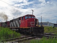 After waiting at the signals to the west for GEXR #431 to clear the single track section of the Halton Sub between Brampton East and Peel, CN SD40-2W 5274 and C44-9W 2587 throttle up and proceed through downtown Brampton, thumping <a href=http://www.railpictures.ca/?attachment_id=35631><b>the diamond</b></a> with the ex-CP OBRY Owen Sound Spur just west of Brampton Station and "Beating the GO Rush" before the first <a href=http://www.railpictures.ca/?attachment_id=10415><b>Georgetown-line GO train</b></a> shows up around 5pm.
<br><br>
At the time the downtown Brampton area of the Halton Sub had a bit of a <a href=http://www.railpictures.ca/?attachment_id=11902><b>vegetation overgrowth problem</b></a> (much to the detriment of photographers), that would later be fixed when CN dug up the area to upgrade the signals around the diamond, and began clearing land to double- and triple-track parts of the Halton Sub through Brampton during the next year. The building in the background used to be an old Pease Swift foundry many years ago (with a siding off CP), before its current use as a self-storage facility. The OBRY would discontinue all operations in <a href=http://www.railpictures.ca/?attachment_id=47392><b>December 2021</b></a>, and the <a href=http://www.railpictures.ca/?attachment_id=54724><b>end finally came</b></a> for the old Brampton diamond when it was ripped out in July 2024. Hard to believe there was once even an interlocking tower here controlling traffic until 1958!